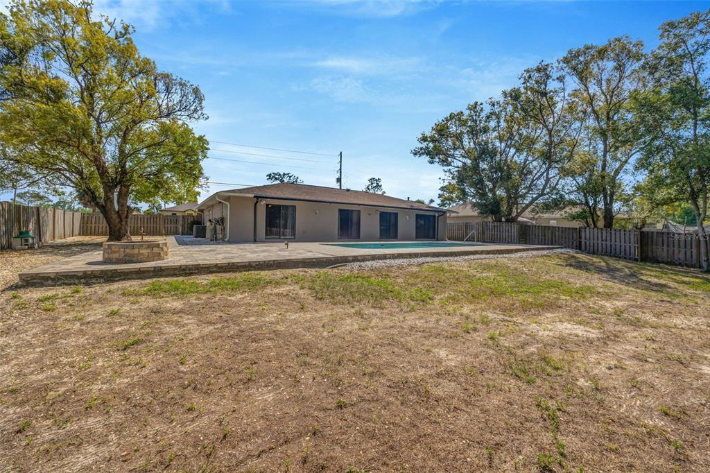 10199 Elgin Boulevard Spring Hill, FL 34608 - Photo 48 of 66 a front view of a house with a yard