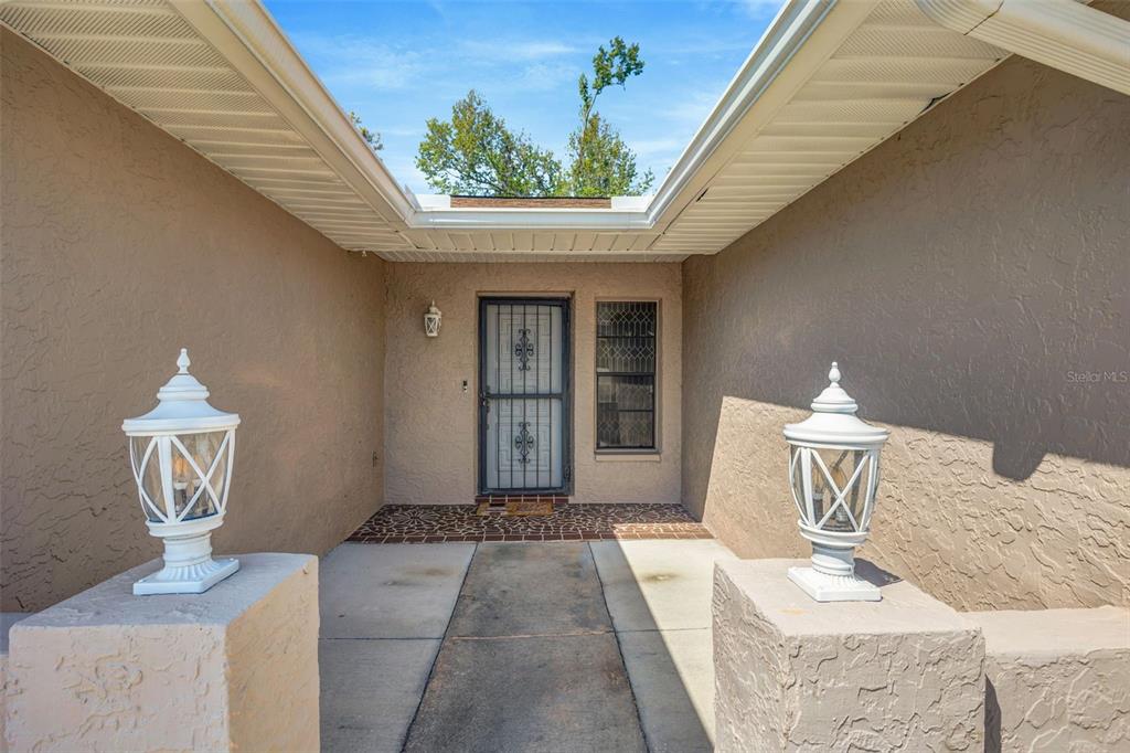 10199 Elgin Boulevard Spring Hill, FL 34608 - Photo 5 of 66 a front view of a house with garden