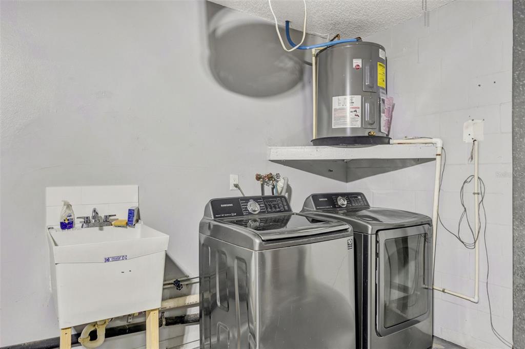 10199 Elgin Boulevard Spring Hill, FL 34608 - Photo 55 of 66 a utility room with dryer and washer