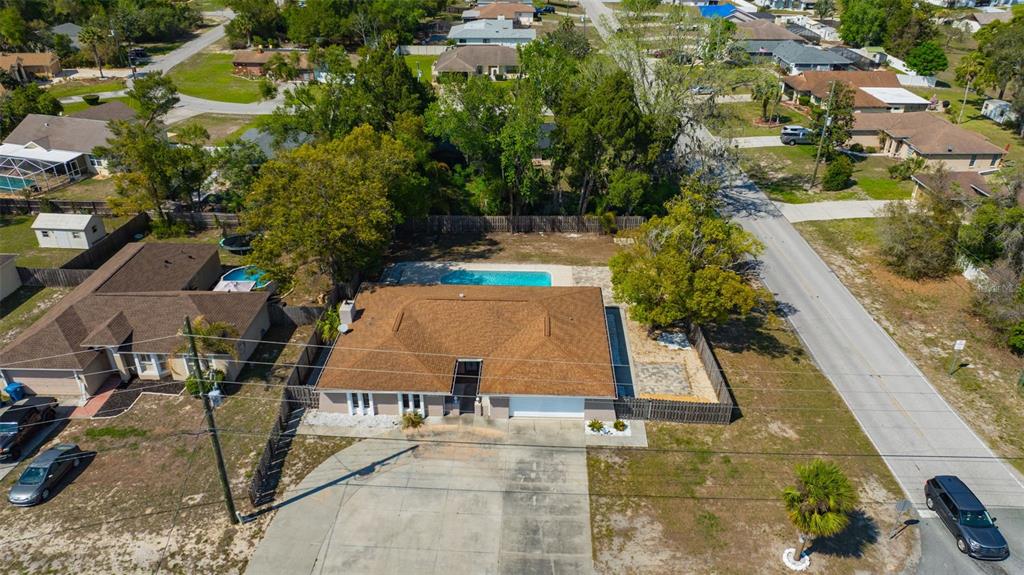 10199 Elgin Boulevard Spring Hill, FL 34608 - Photo 60 of 66 an aerial view of a house with swimming pool