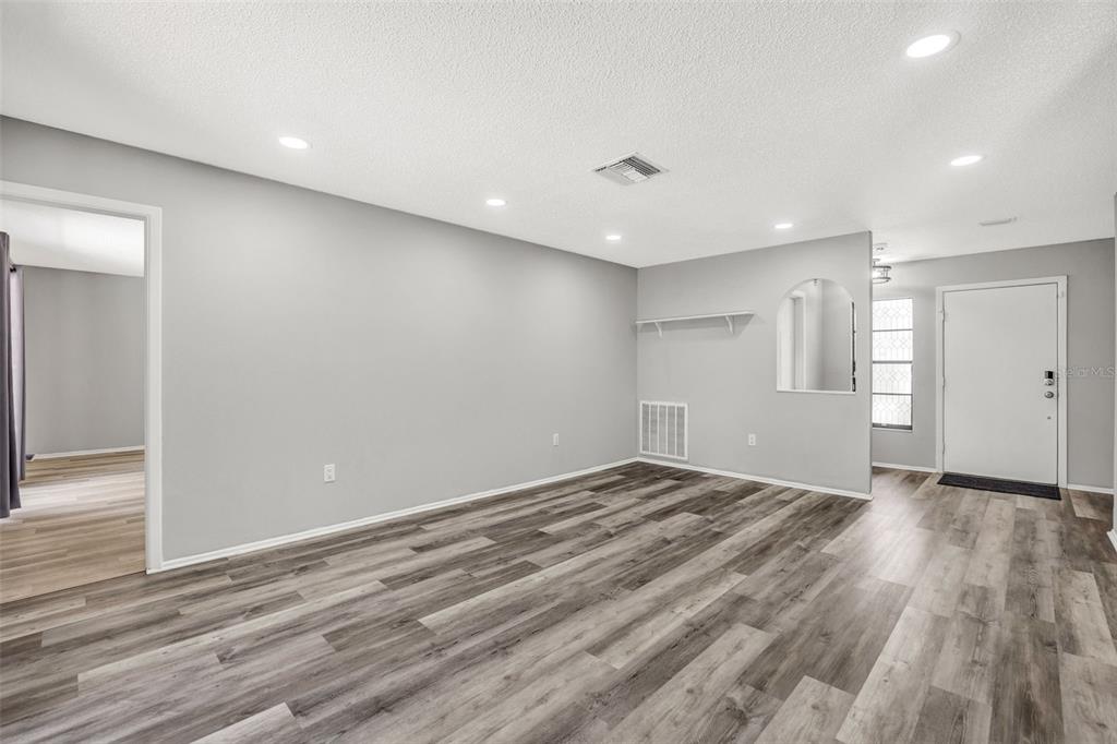 10199 Elgin Boulevard Spring Hill, FL 34608 - Photo 10 of 66 a view of empty room with wooden floor