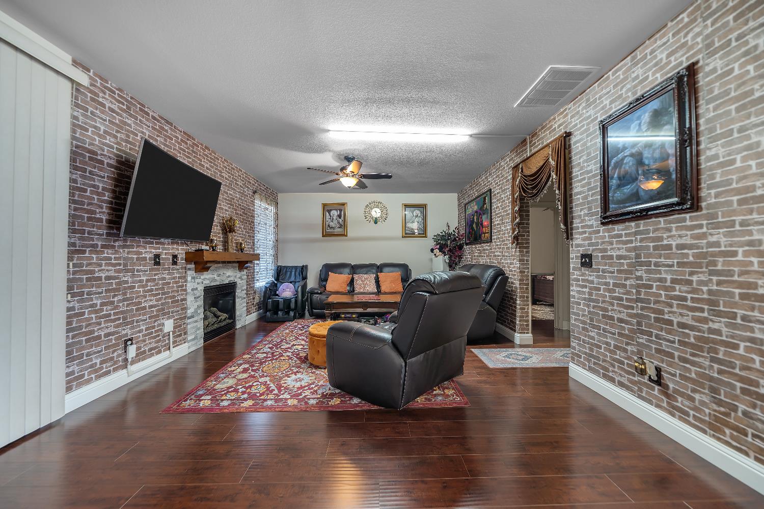 1114 Kay Circle Turlock, CA 95382 - Photo 11 of 40 a living room with fireplace furniture and a flat screen tv