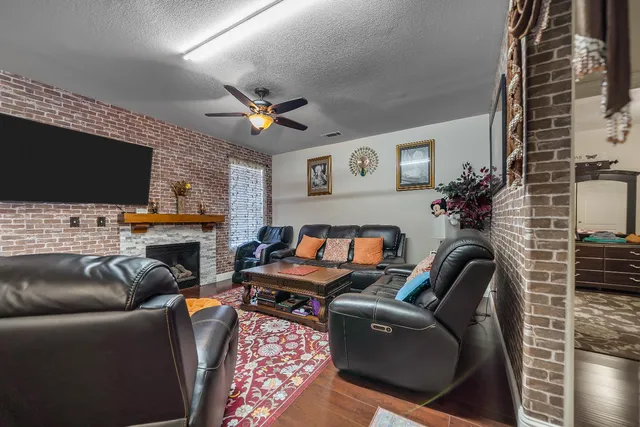 a living room with furniture a flat screen tv and a fireplace