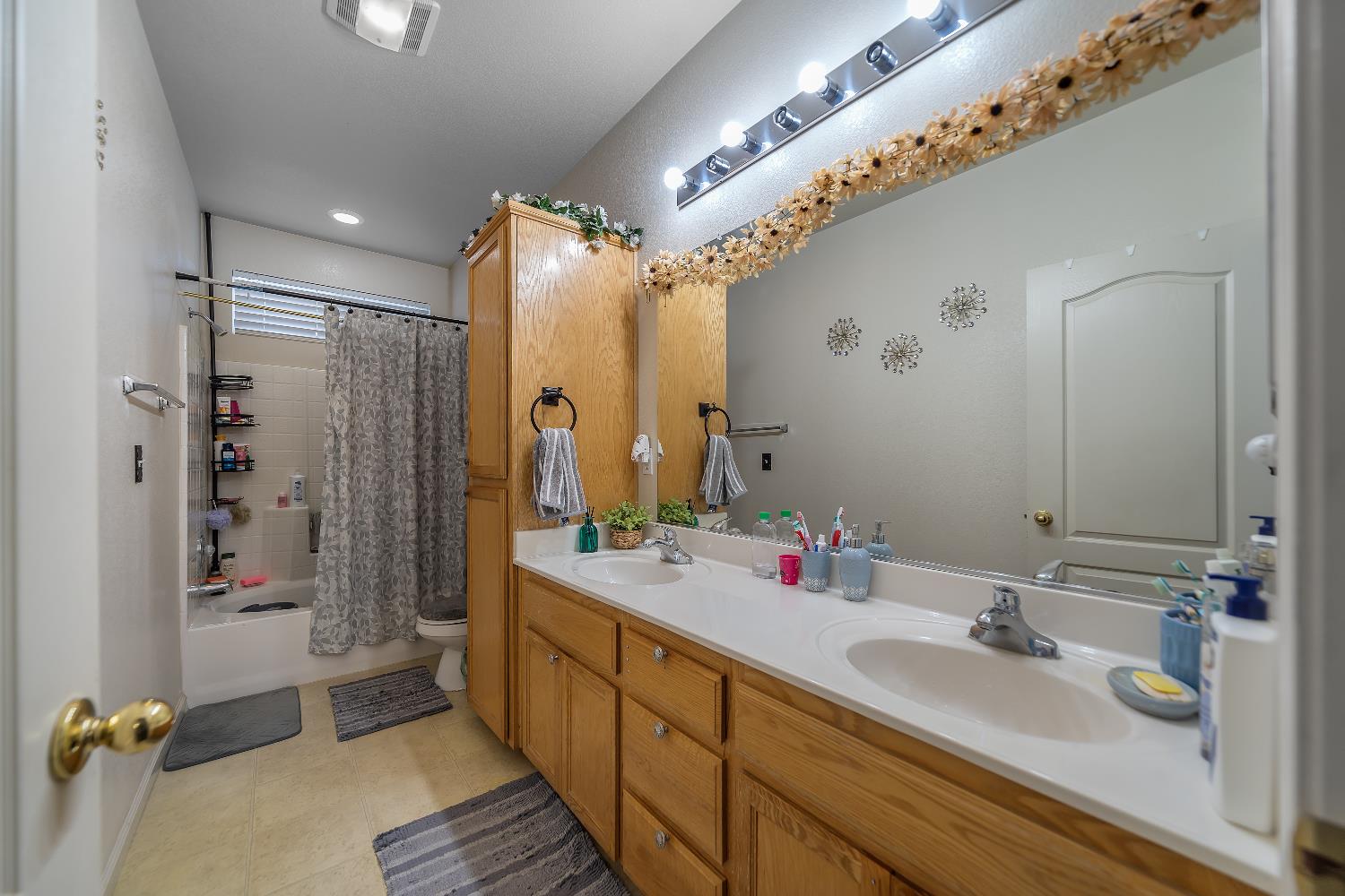 1114 Kay Circle Turlock, CA 95382 - Photo 15 of 40 a bathroom with a double vanity sink mirror and shower