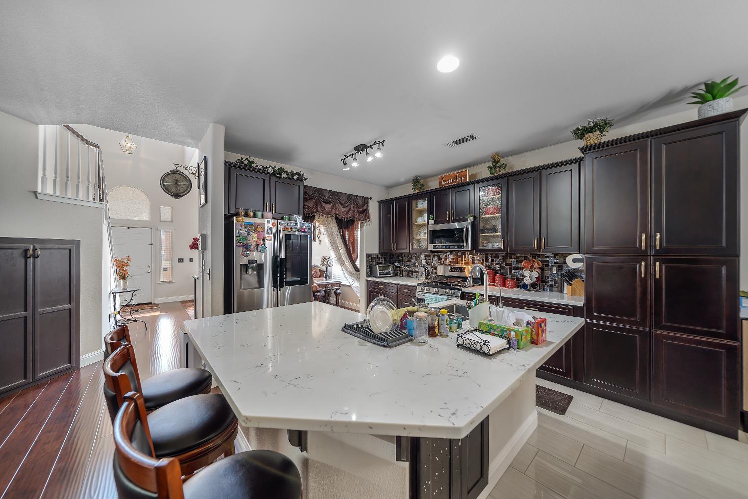 1114 Kay Circle Turlock, CA 95382 - Photo 20 of 40 a kitchen with refrigerator and cabinets