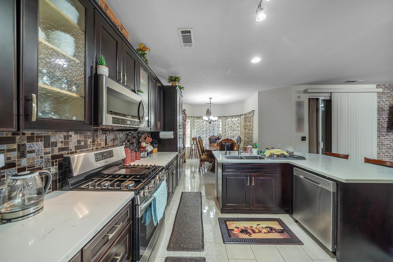 1114 Kay Circle Turlock, CA 95382 - Photo 22 of 40 a kitchen with stainless steel appliances a sink stove and cabinets