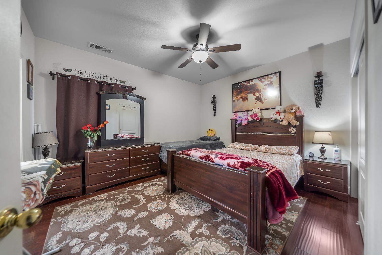 1114 Kay Circle Turlock, CA 95382 - Photo 25 of 40 a bedroom with a bed and a mirror