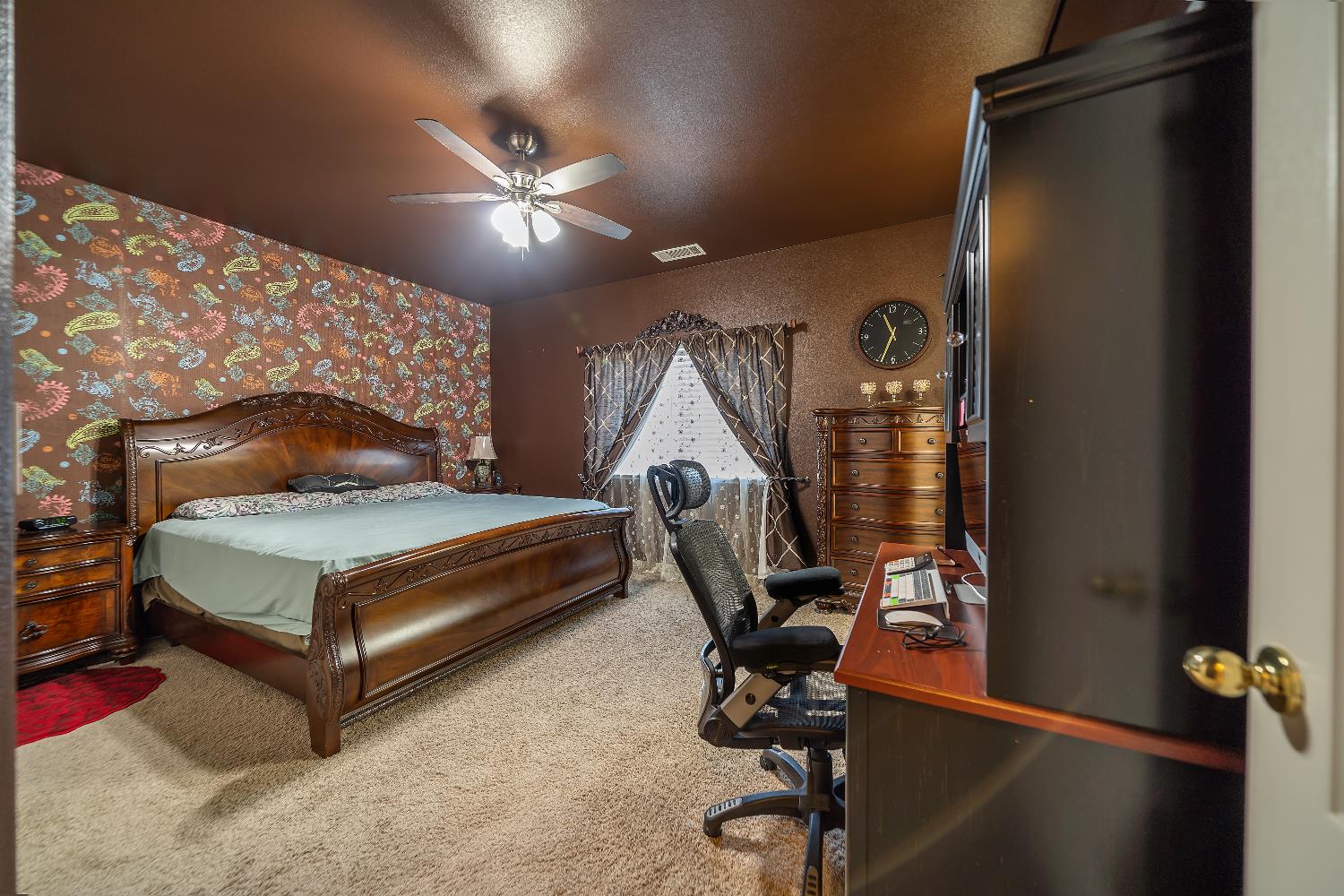 1114 Kay Circle Turlock, CA 95382 - Photo 30 of 40 a bedroom with a bed and a chandelier