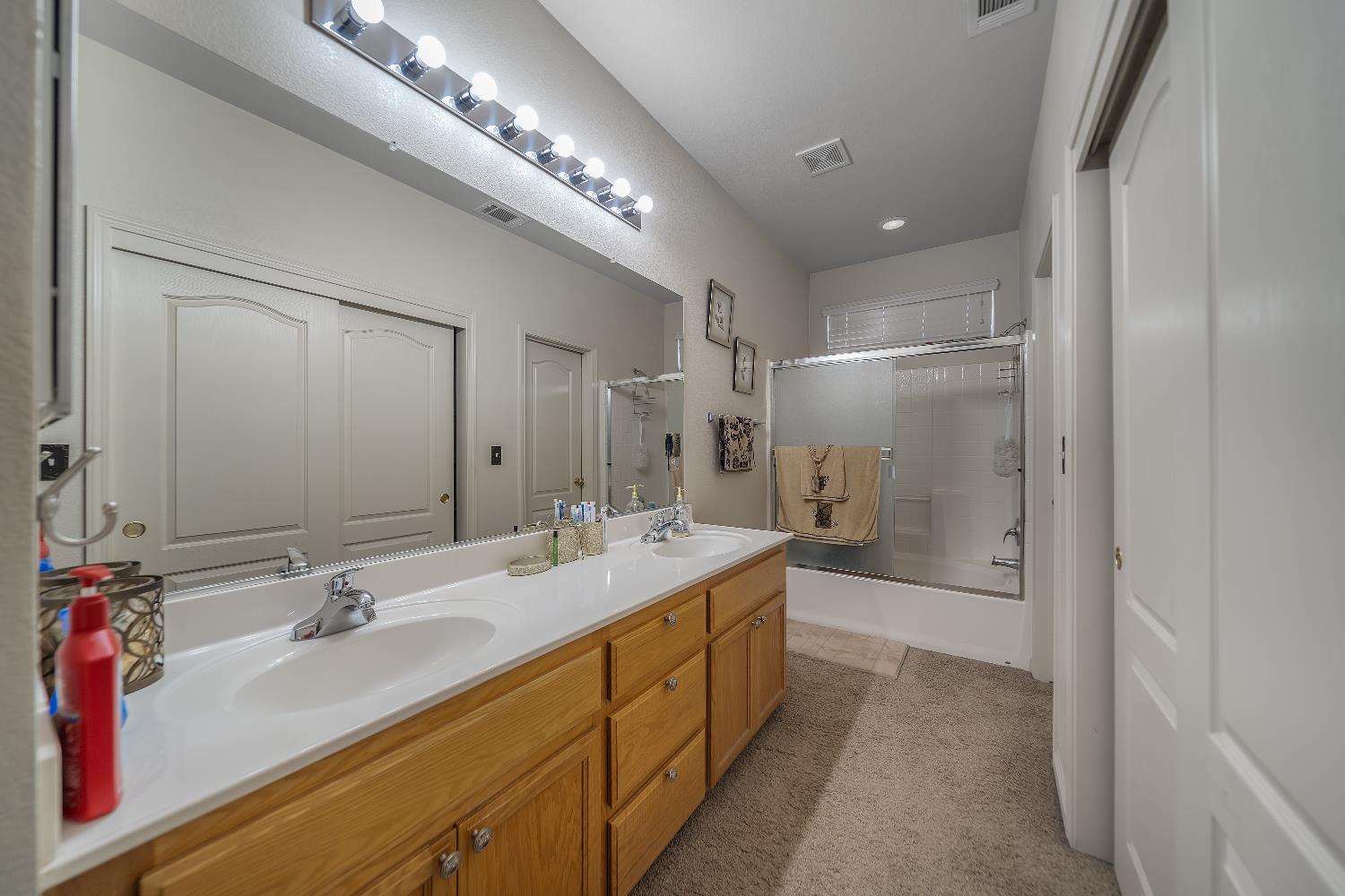 1114 Kay Circle Turlock, CA 95382 - Photo 32 of 40 a spacious bathroom with a double vanity sink mirror double and shower