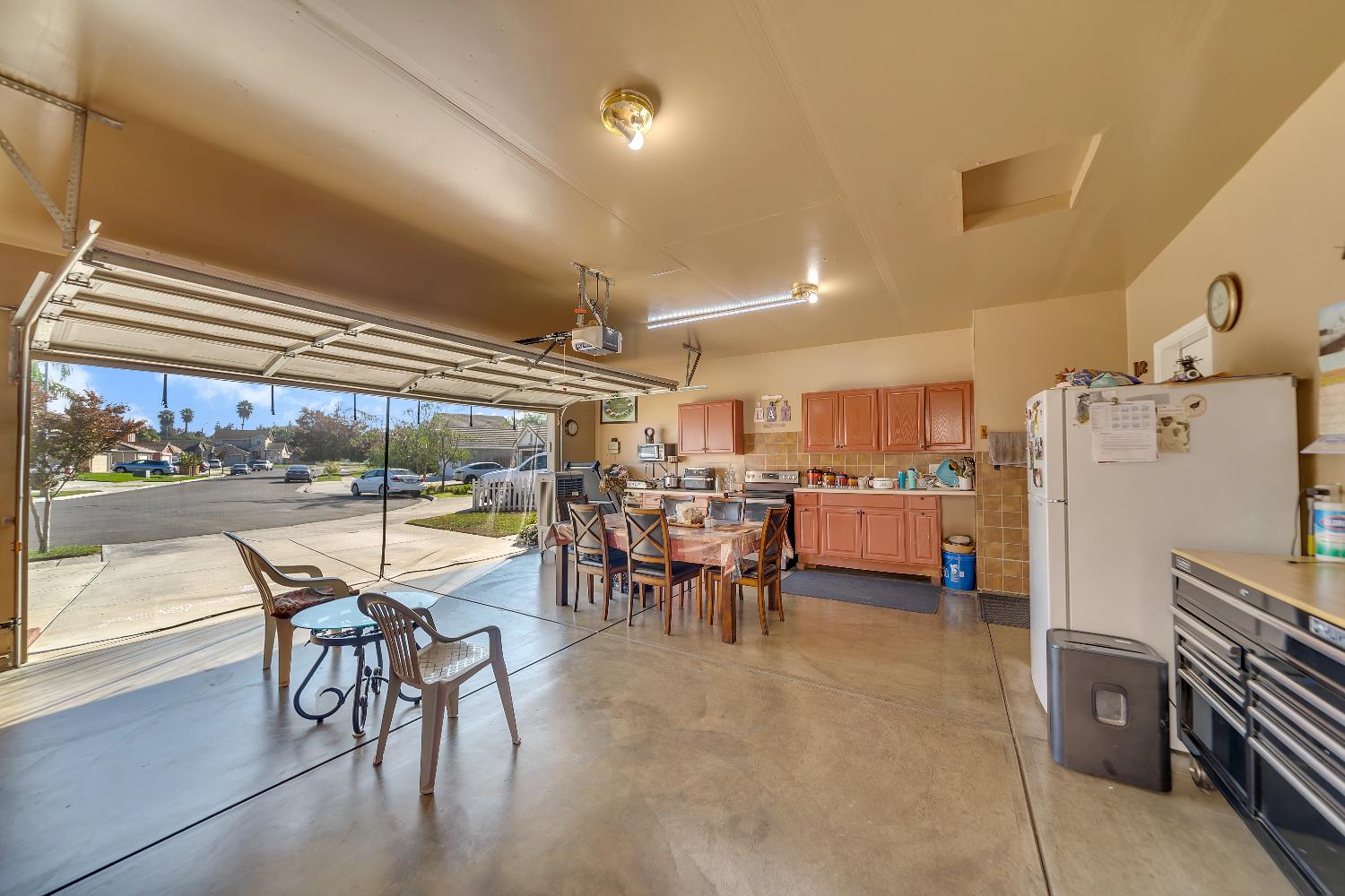 1114 Kay Circle Turlock, CA 95382 - Photo 39 of 40 a room with lots of wooden furniture and stainless steel appliances