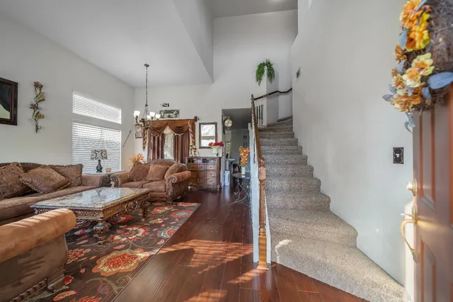 a living room with furniture and a chandelier