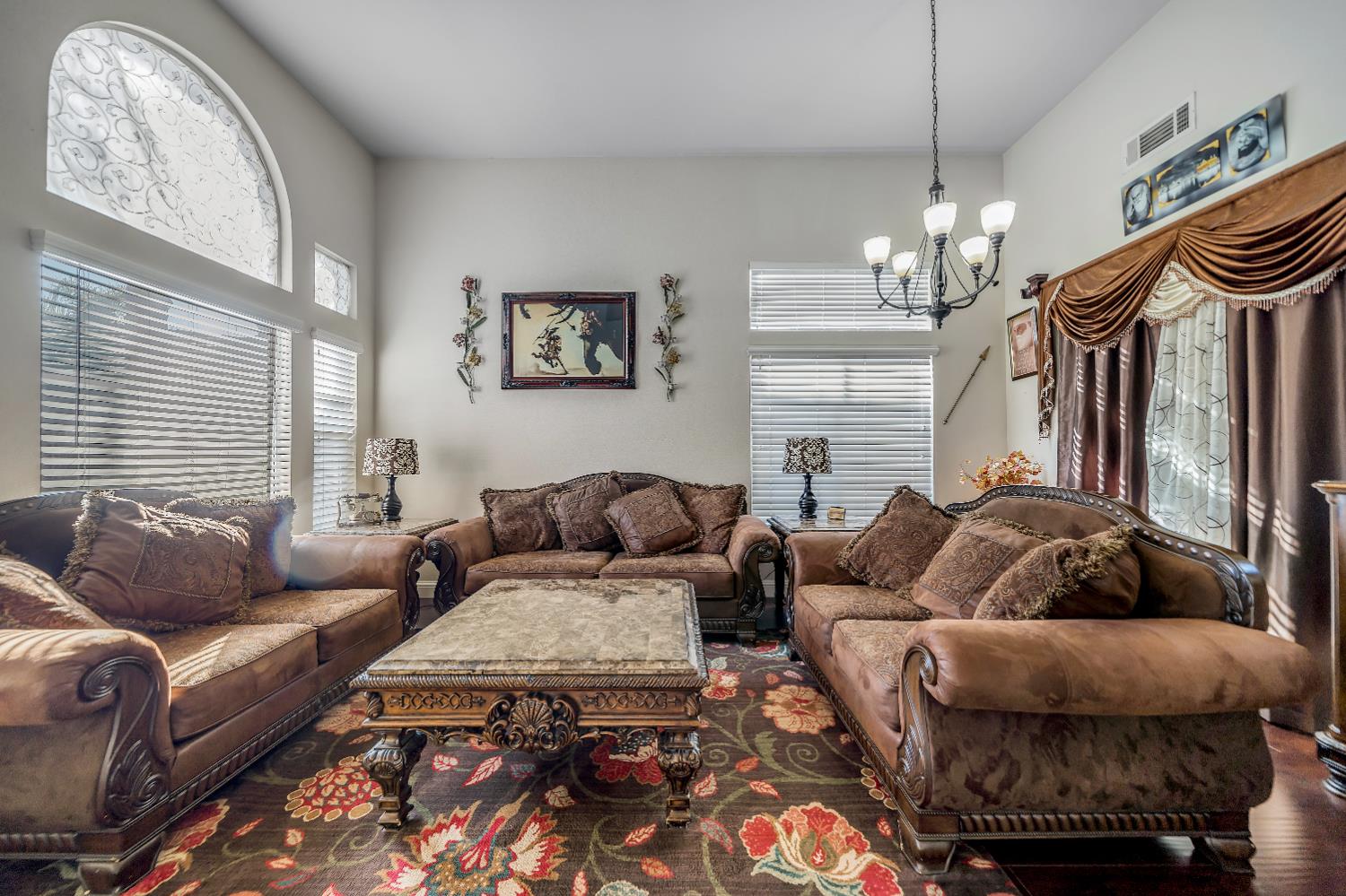 1114 Kay Circle Turlock, CA 95382 - Photo 7 of 40 a living room with furniture a chandelier and a window