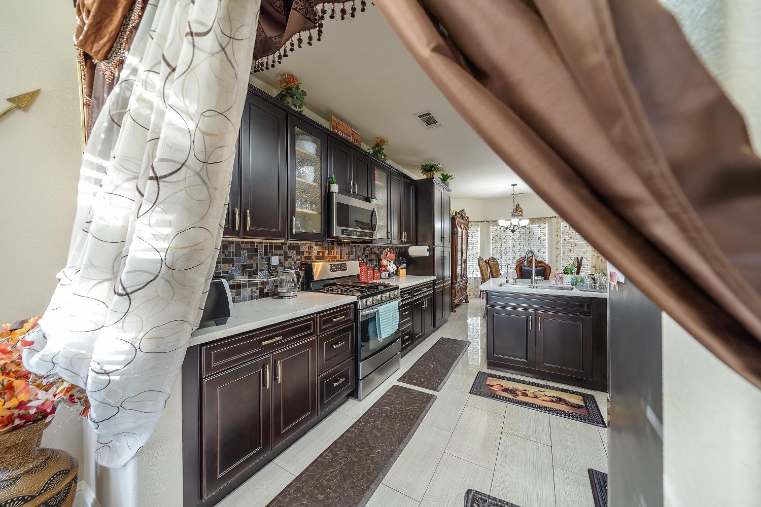1114 Kay Circle Turlock, CA 95382 - Photo 9 of 40 a kitchen with stainless steel appliances granite countertop a stove and a sink