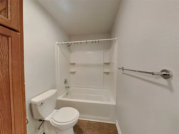 a bathroom with a toilet and a bathtub