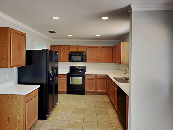 a kitchen with stainless steel appliances granite countertop a refrigerator and a stove
