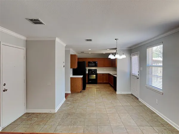 a large kitchen with a refrigerator and a sink
