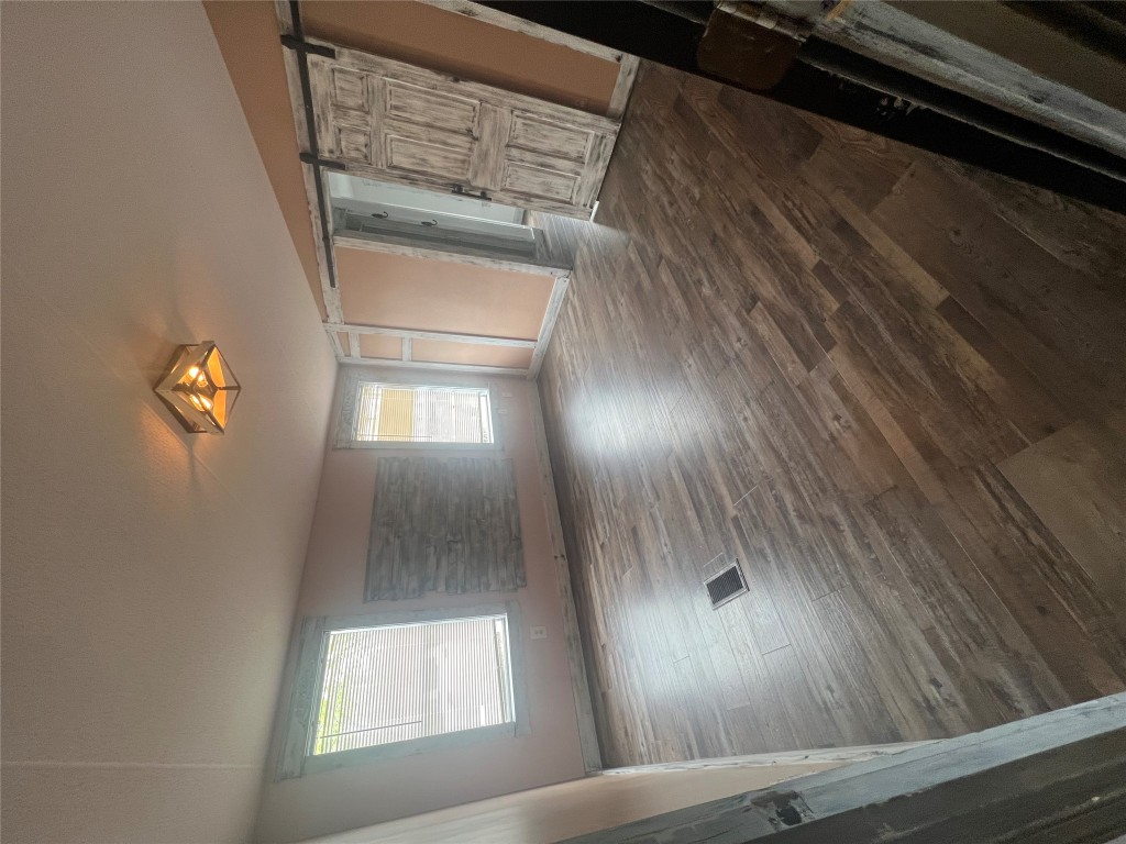 106 Bridle Path, Unit B Kyle, TX 78640 - Photo 11 of 25 wooden floor in an empty room with a window