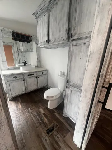 a bathroom with a granite countertop sink toilet and shower