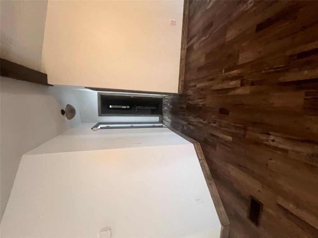 106 Bridle Path, Unit B Kyle, TX 78640 - Photo 17 of 25 a view of a big room with wooden floor and windows