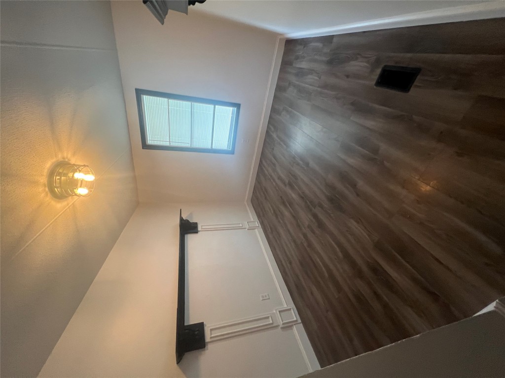 106 Bridle Path, Unit B Kyle, TX 78640 - Photo 19 of 25 wooden floor in an empty room with a window