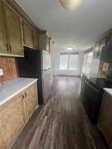 a kitchen with stainless steel appliances a refrigerator and a stove