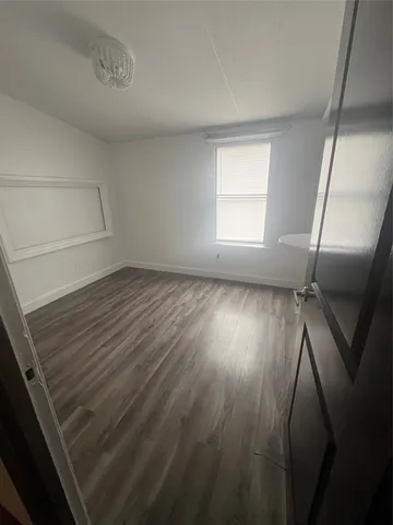 a view of wooden floor and windows in a room