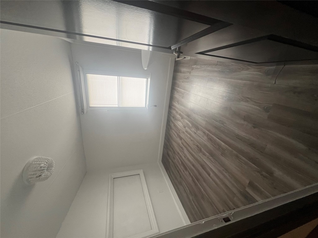 106 Bridle Path, Unit B Kyle, TX 78640 - Photo 22 of 25 a view of wooden floor and windows in a room