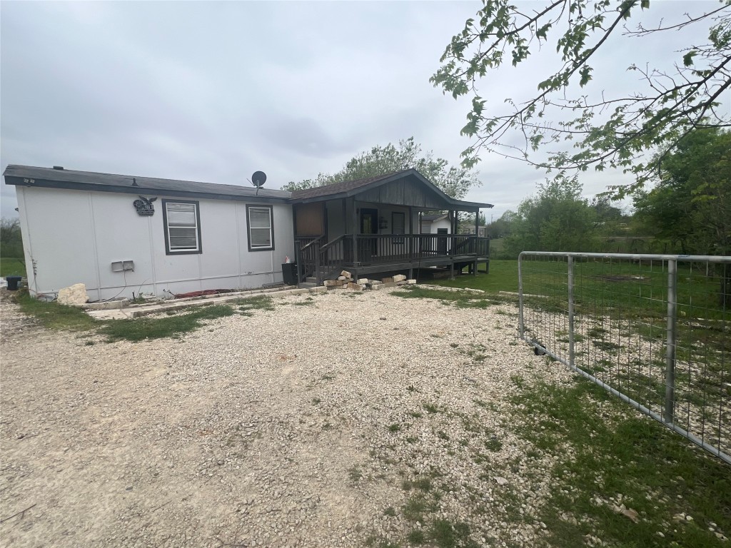 106 Bridle Path, Unit B Kyle, TX 78640 - Photo 25 of 25 a backyard of house with large trees and wooden fence