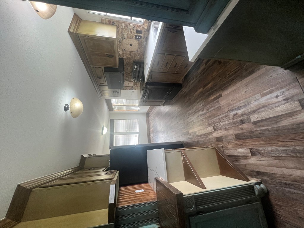 106 Bridle Path, Unit B Kyle, TX 78640 - Photo 4 of 25 a kitchen with stainless steel appliances granite countertop a sink a stove and a wooden floors