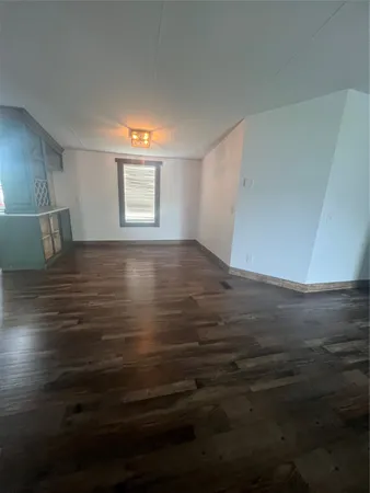 a view of room with window and wooden floor