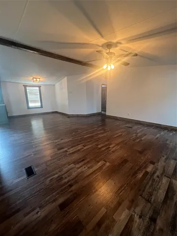 a view of a room with wooden floor