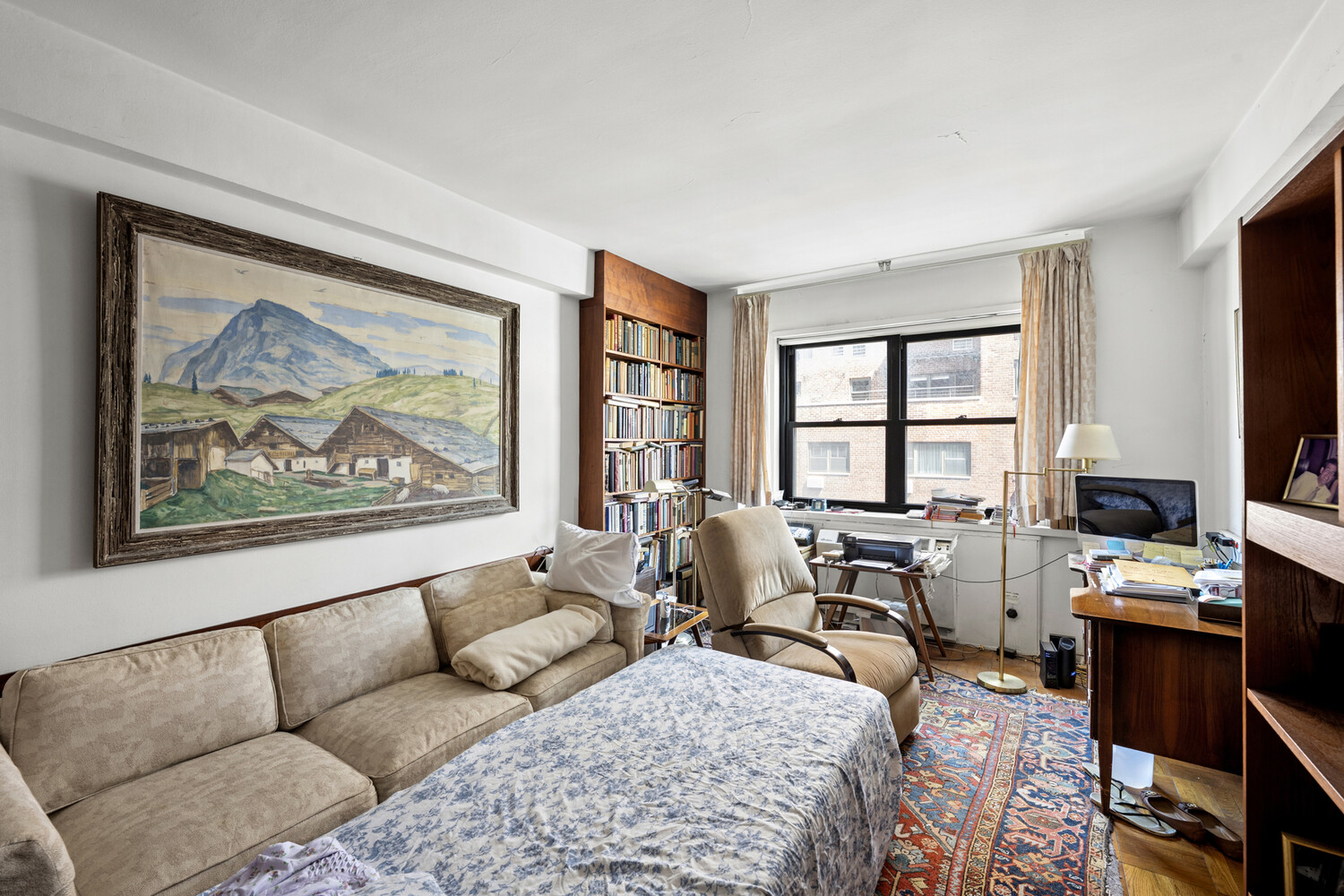 165 East 72nd Street, Unit 12J Manhattan, NY 10021 - Photo 7 of 13 a living room with furniture and a window