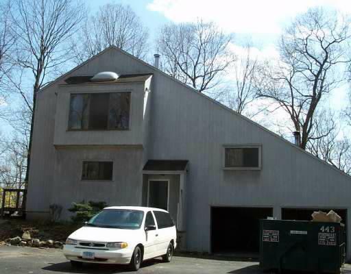 a front view of a house with parking space