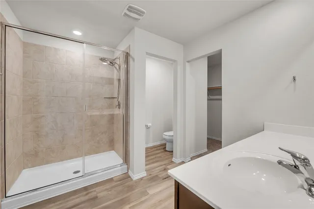 a bathroom with a shower and a sink
