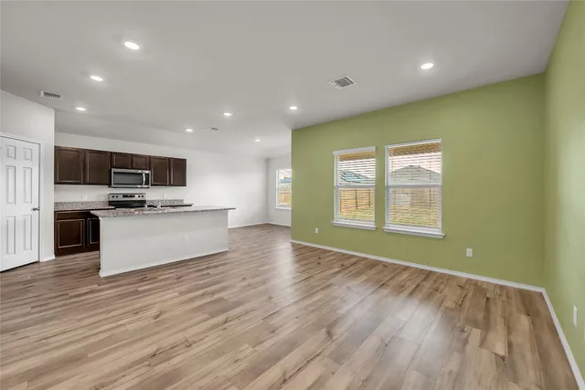 a kitchen with stainless steel appliances granite countertop a sink a stove a refrigerator and a oven