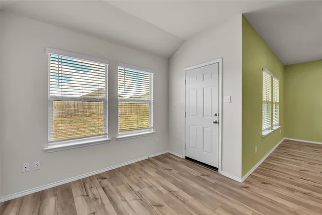 a view of kitchen with granite countertop stainless steel appliances and sink