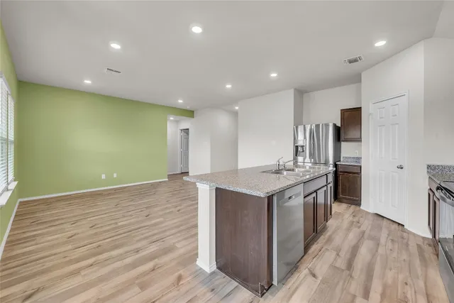 a kitchen with stainless steel appliances a refrigerator stove and microwave