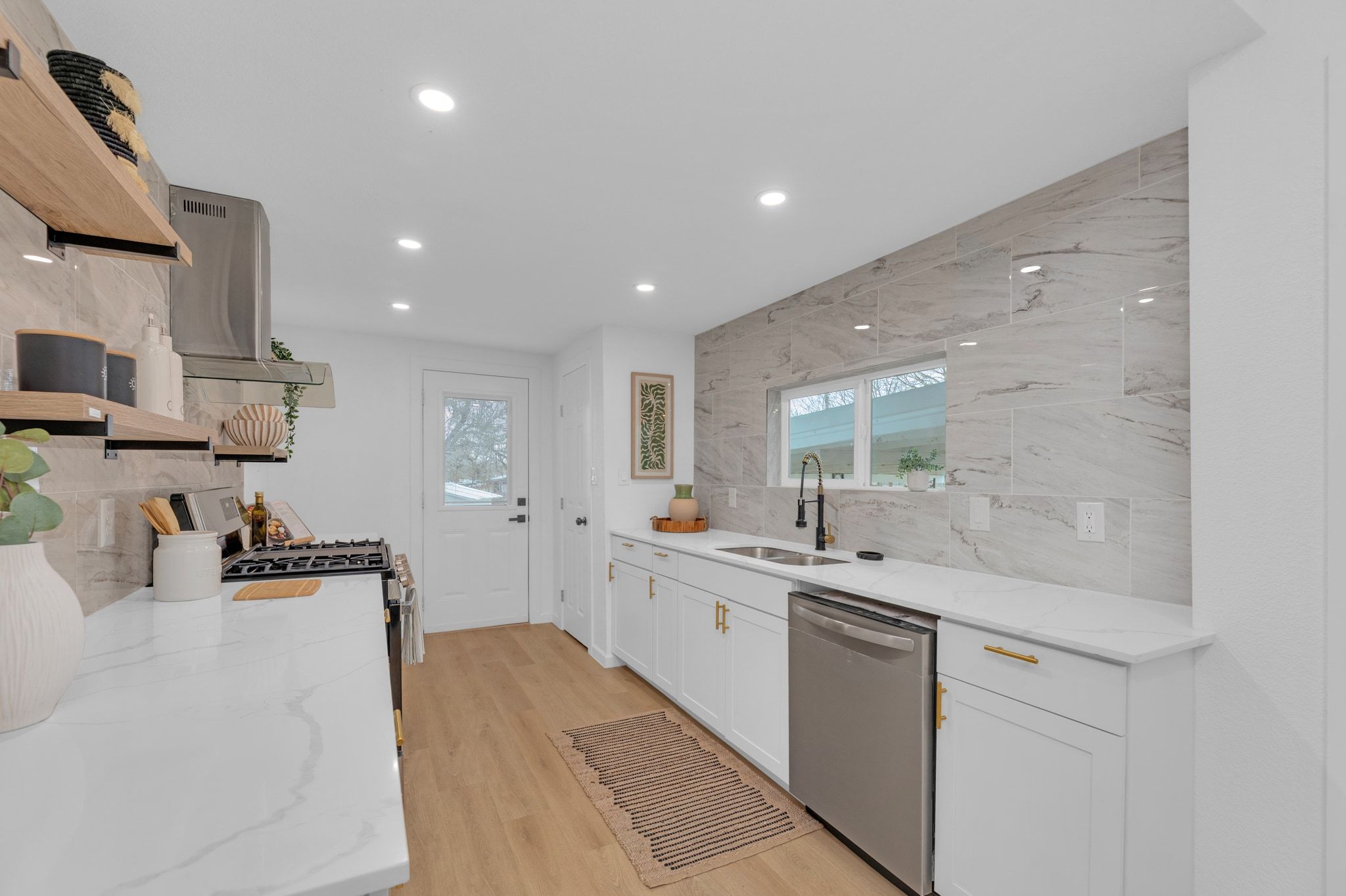 1709 Cecelia Street Taylor, TX 76574 - Photo 14 of 38 Kitchen featuring open shelves, light stone countertops, stainless steel appliances, healthy amount of natural light, and recessed lighting