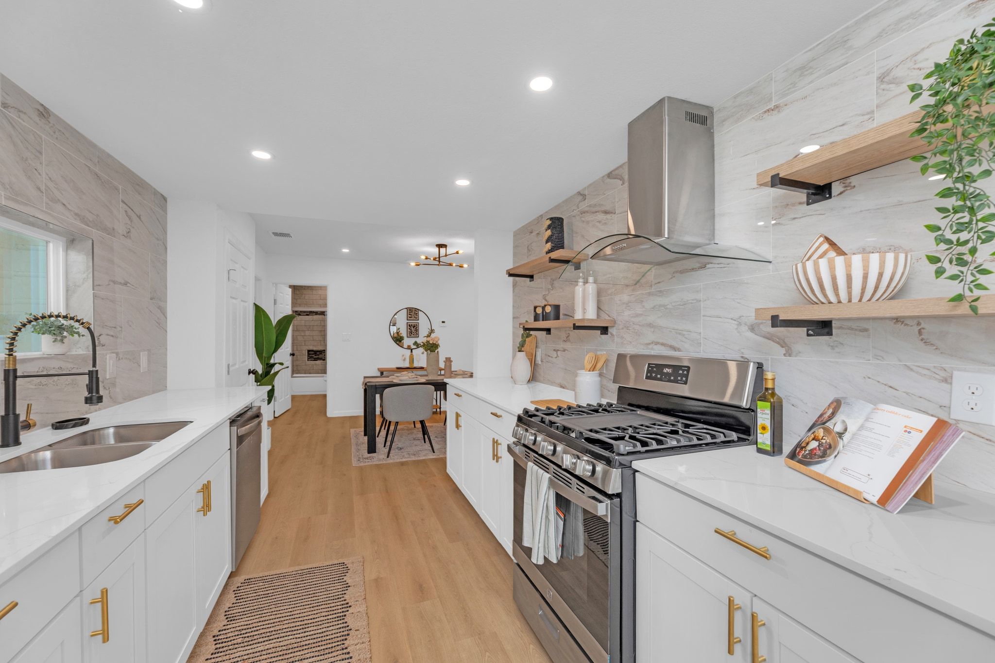 1709 Cecelia Street Taylor, TX 76574 - Photo 16 of 38 Kitchen with open shelves, stainless steel appliances, white cabinetry, light stone countertops, and ventilation hood