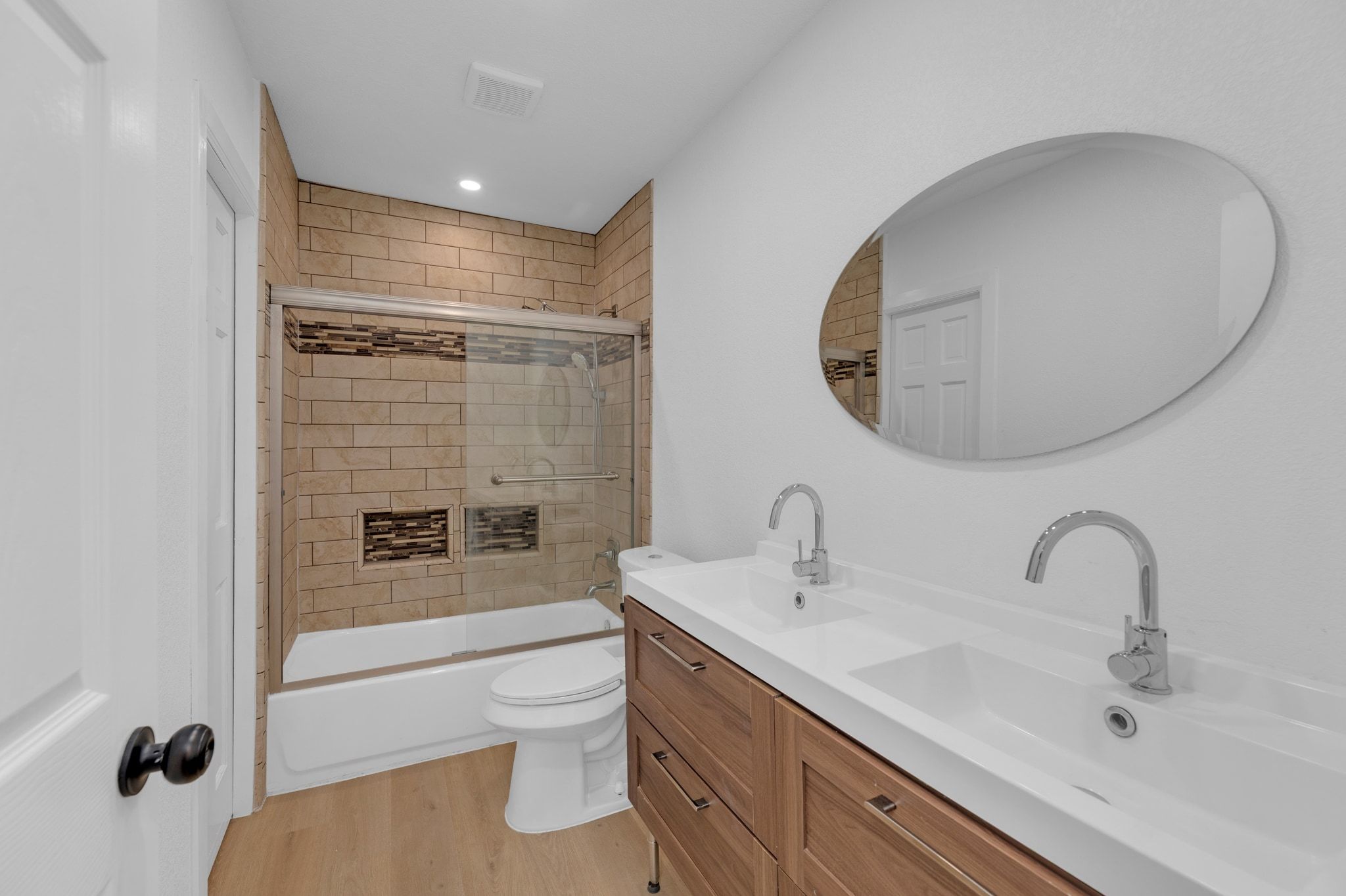 1709 Cecelia Street Taylor, TX 76574 - Photo 29 of 38 Full bathroom with double vanity, light wood-style flooring, shower / bath combination with glass door, and recessed lighting