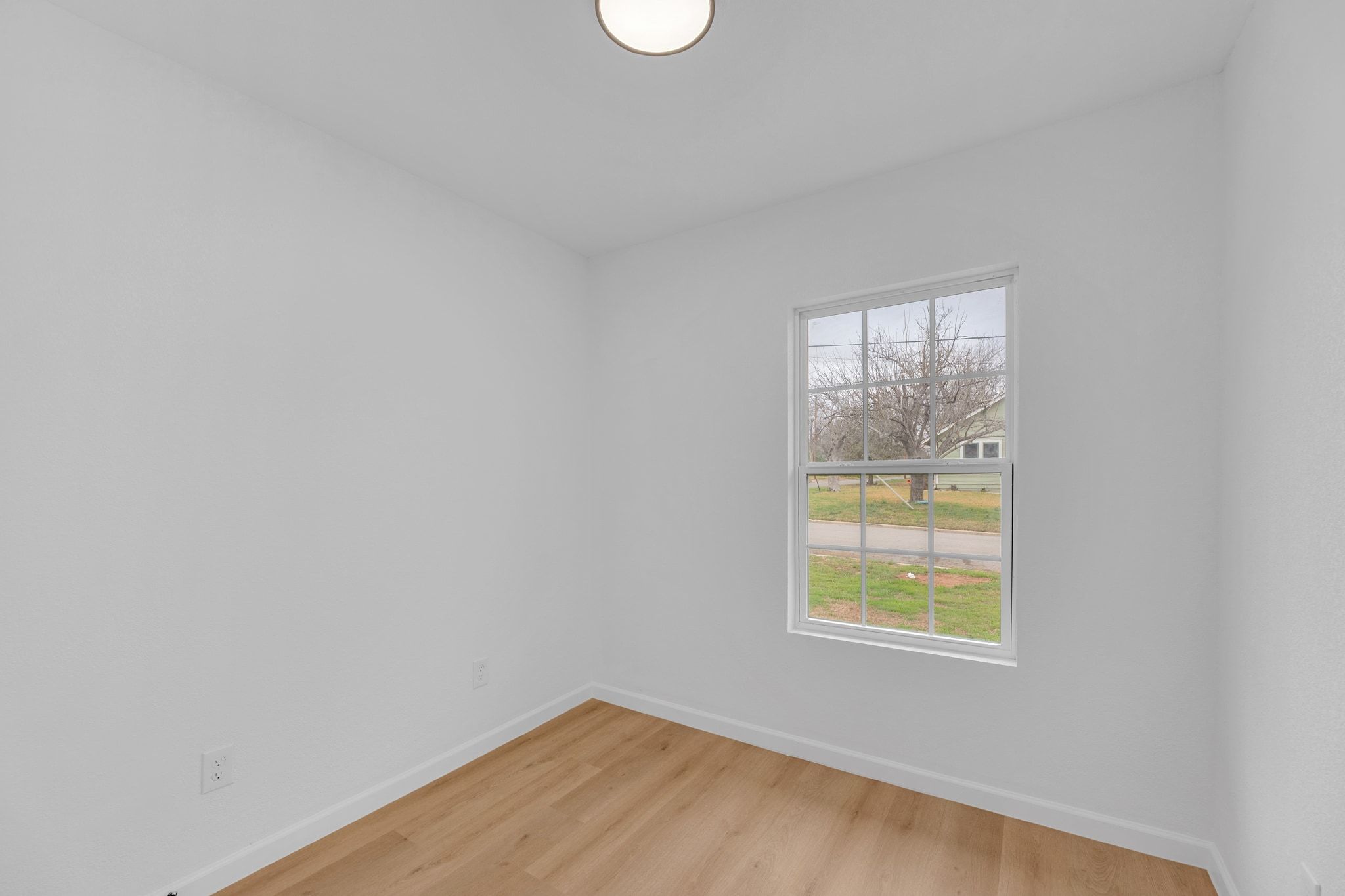 1709 Cecelia Street Taylor, TX 76574 - Photo 30 of 38 Unfurnished room featuring baseboards and light wood-style flooring