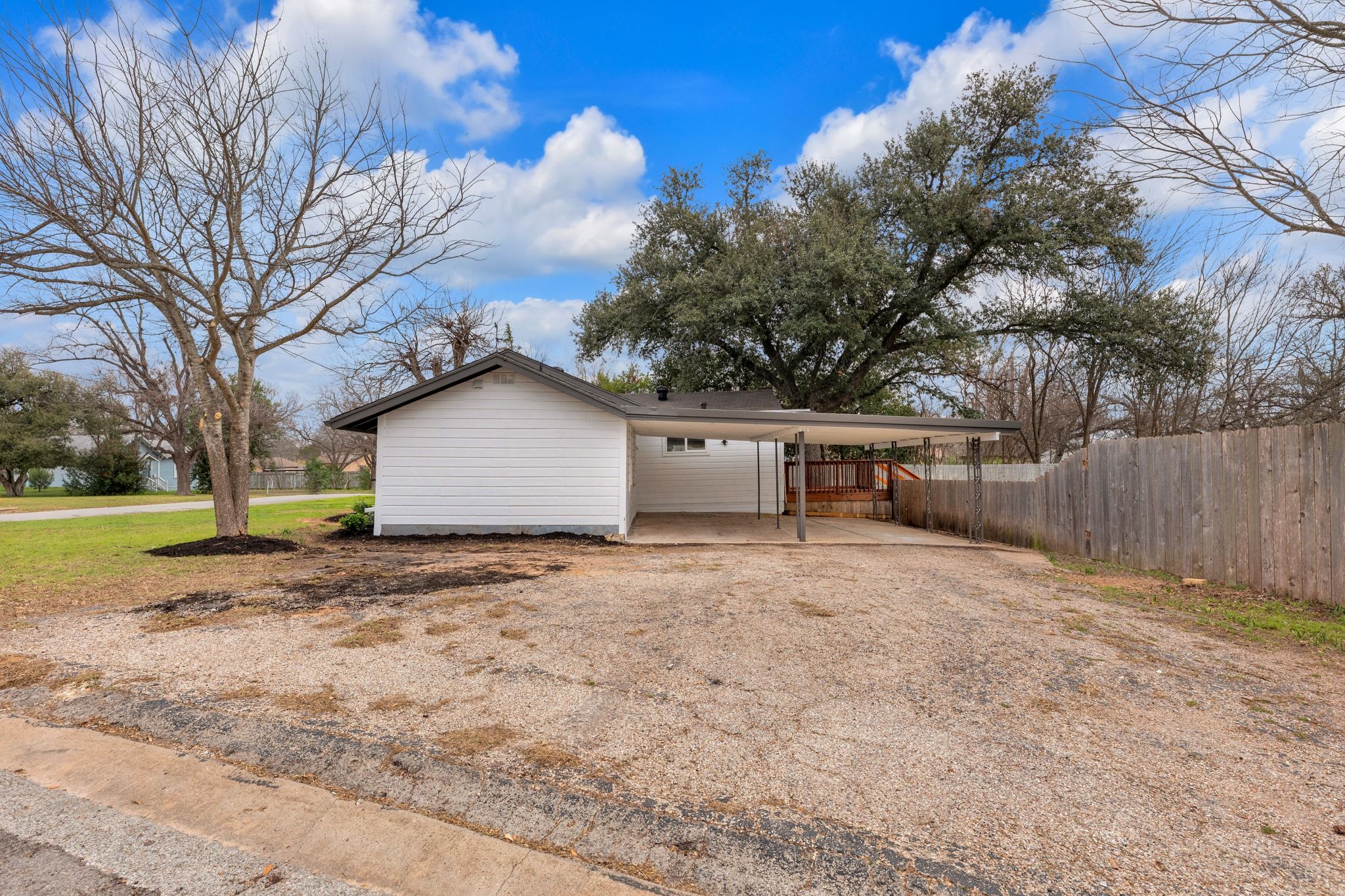 1709 Cecelia Street Taylor, TX 76574 - Photo 5 of 38 Garage featuring driveway and a carport