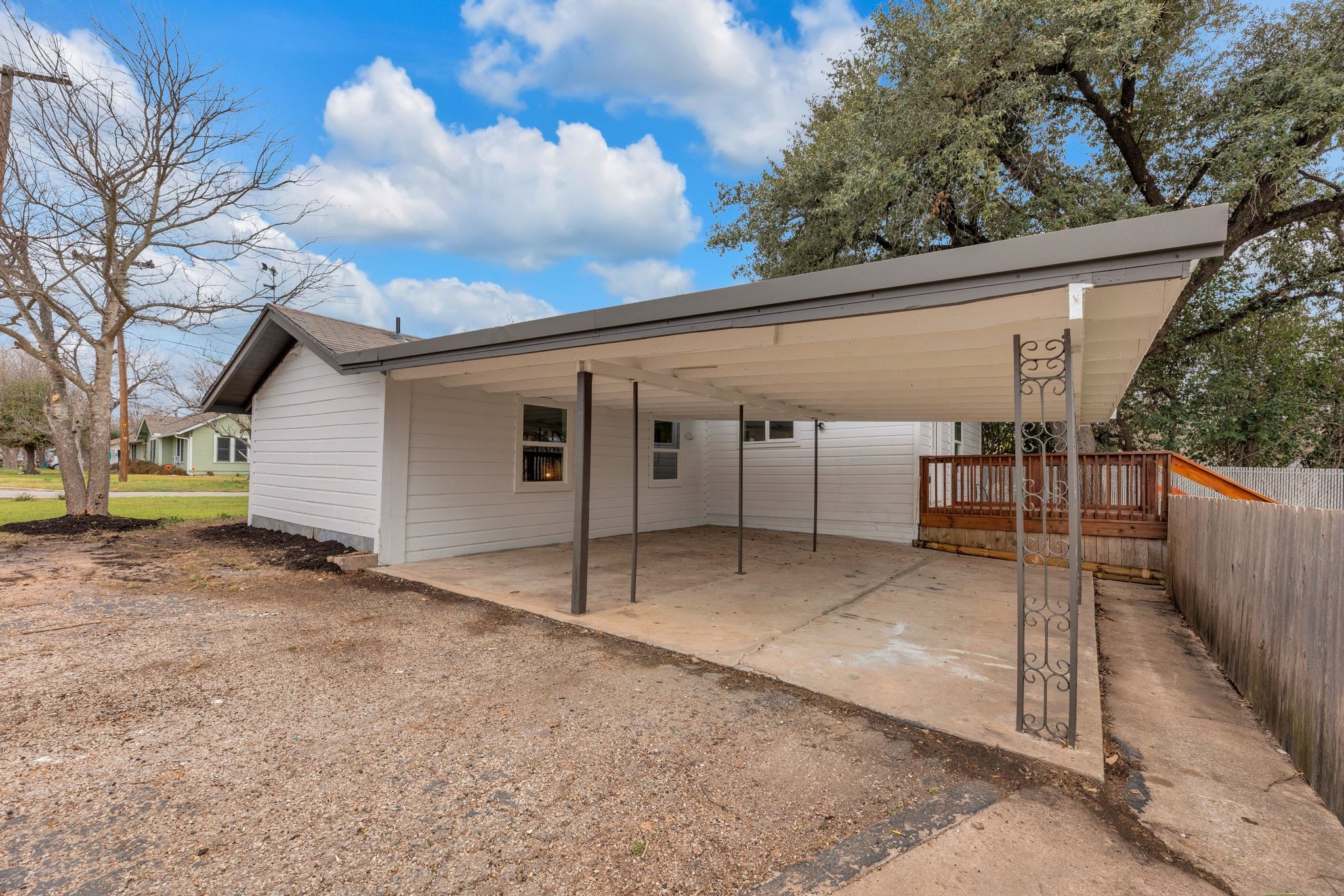 1709 Cecelia Street Taylor, TX 76574 - Photo 6 of 38 Rear view of house featuring a patio, driveway, and a carport