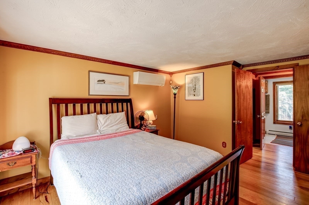 205 East Rindge Road Ashburnham, MA 01430 - Photo 31 of 40 a bedroom with a bed and wooden floor