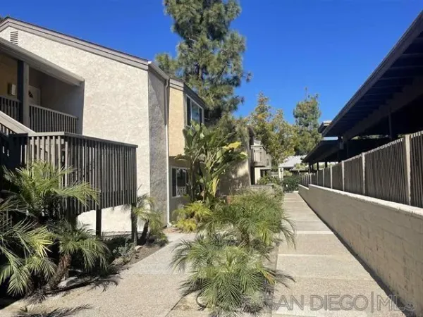 a view of a pathway of a house with a yard