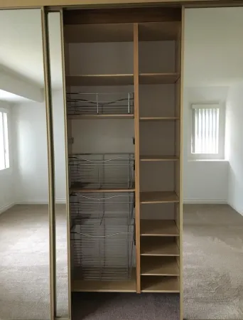 a view of walk in closet with empty racks