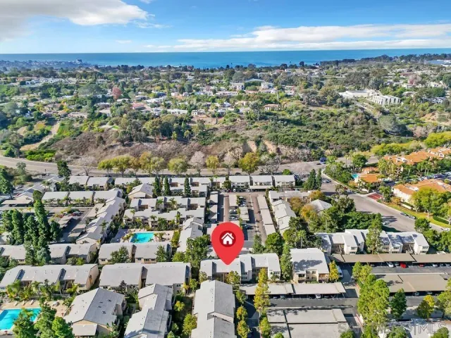 an aerial view of residential building and parking space