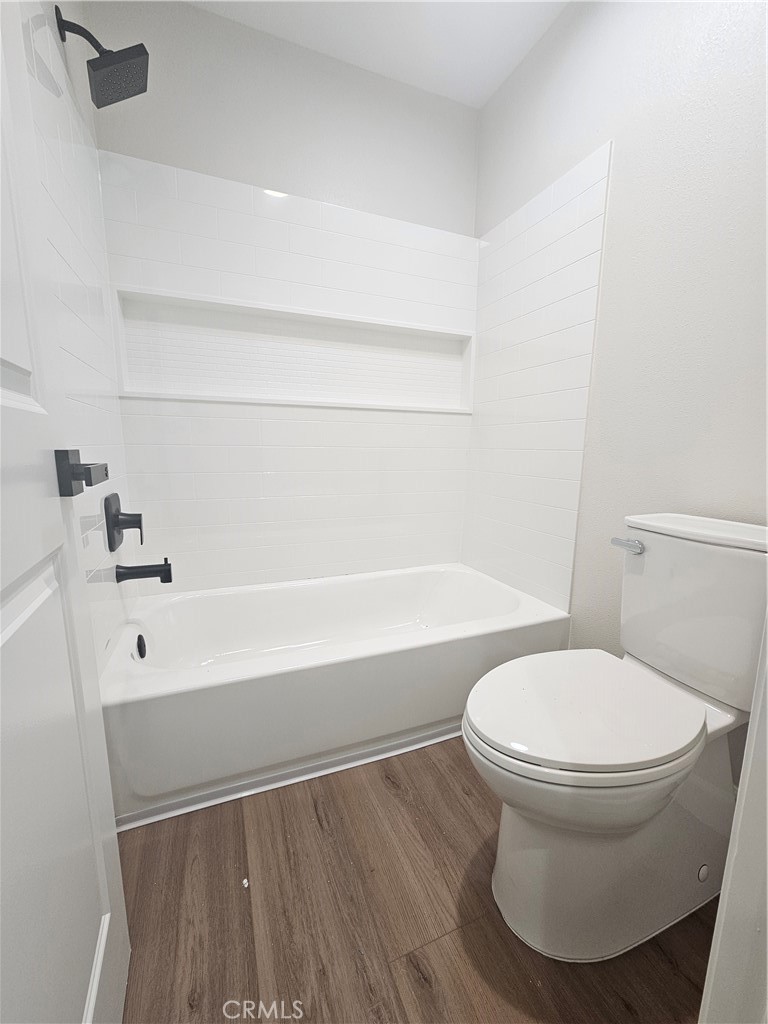 7890 East Spring Street Long Beach, CA 90815 - Photo 4 of 8 a bathroom with a toilet and a tub
