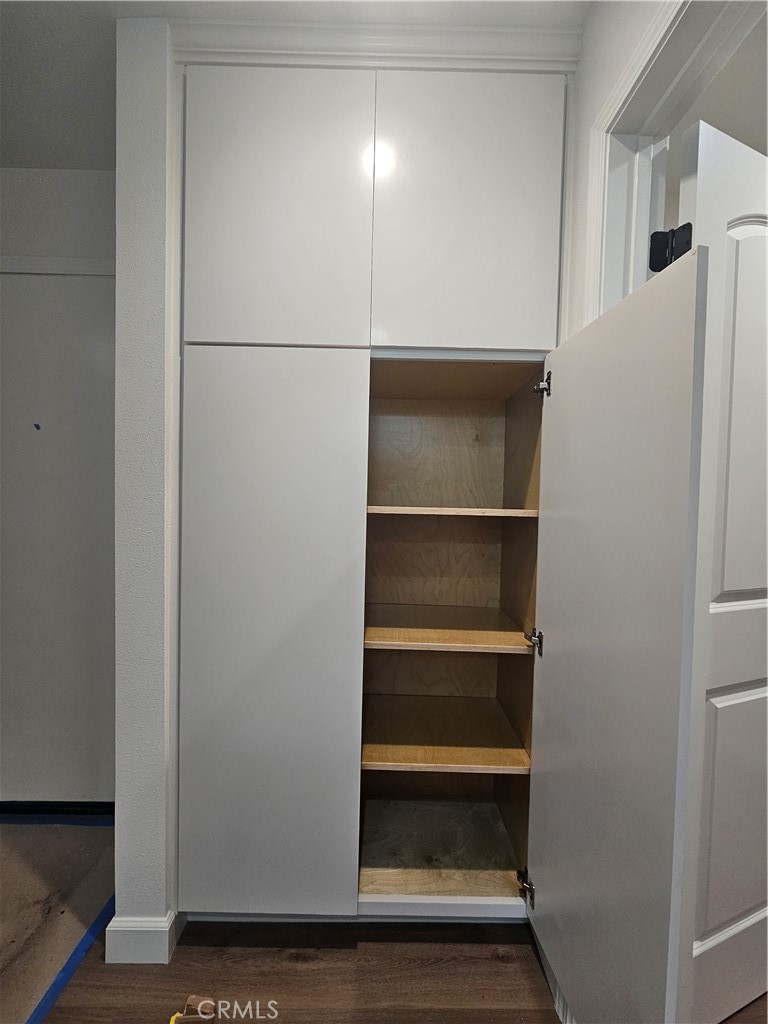 7890 East Spring Street Long Beach, CA 90815 - Photo 6 of 8 a view of walk in closet with empty racks