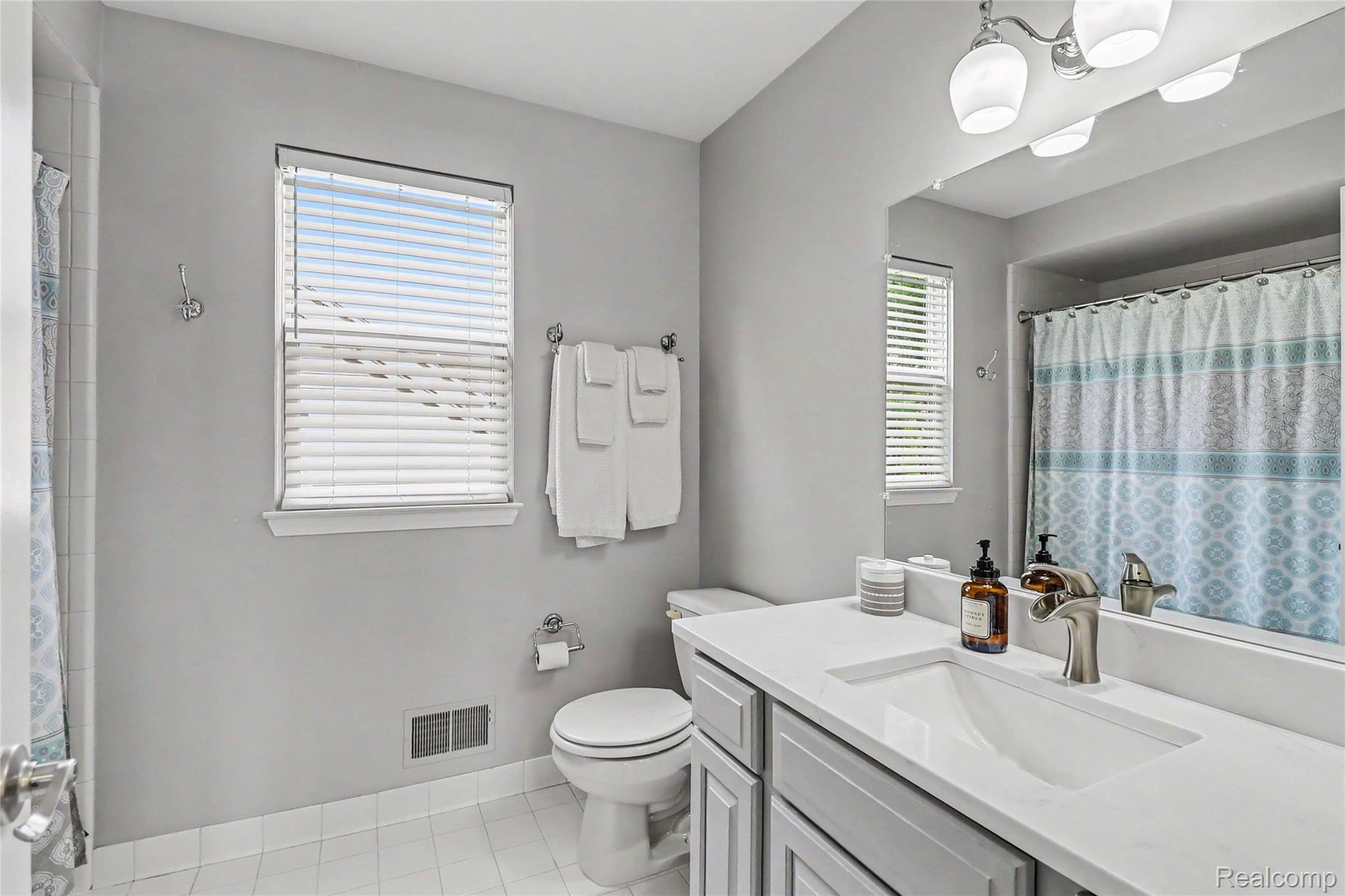 2548 Empire Court Rochester, MI 48309 - Photo 31 of 40 Bathroom featuring a single vanity with an integrated sink, polished chrome faucet, and overhead lighting